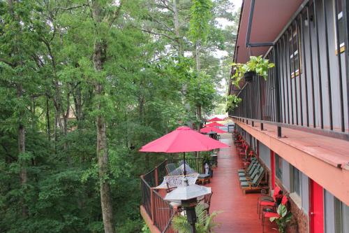 a balcony with tables and umbrellas on a building at Brydan Suites in Eureka Springs