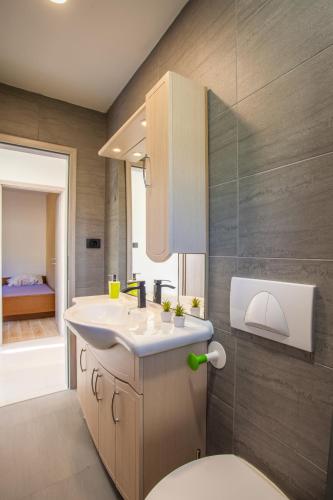 a bathroom with a sink and a toilet at Apartments Borić in Cres