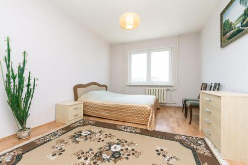 ein Schlafzimmer mit einem Bett, einer Kommode und einem Fenster in der Unterkunft Apartment on Grygorenko street in Kiew