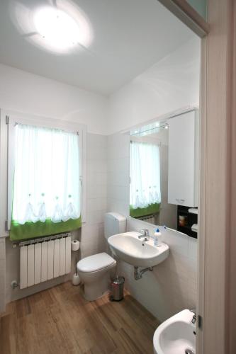 a white bathroom with a sink and a toilet at Venice Loft in Marghera