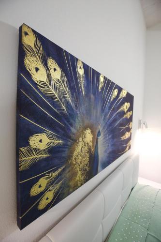 a picture of a peacock painting on a wall at Venice Loft in Marghera