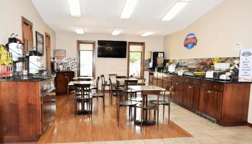 a bar with tables and chairs in a restaurant at Baymont by Wyndham Pierre in Pierre
