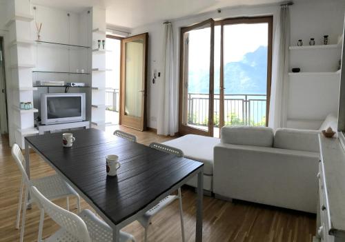 a living room with a table and a couch at Residence Fairy Tale in Bellano