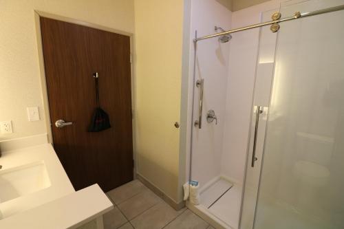 a bathroom with a shower with a glass door at Holiday Inn Express & Suites - Coffeyville by IHG in Coffeyville