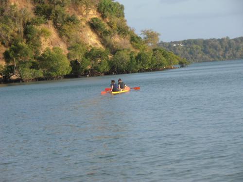 two people in a kayak on a body of water at Sunset villas Tropical Garden House in Kilifi