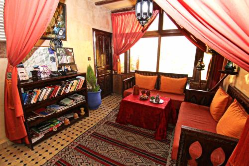 a living room with a couch and a table and a window at Atlas Prestige in Imlil