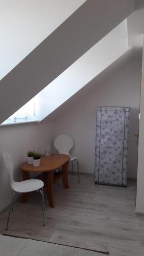 a dining room with a wooden table and chairs at Azalia 32 Mielno l in Mielno