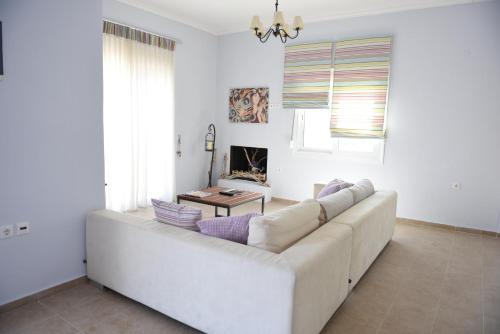 a white couch in a living room with a table at Dimitris' & Valentina's Home in Plakias