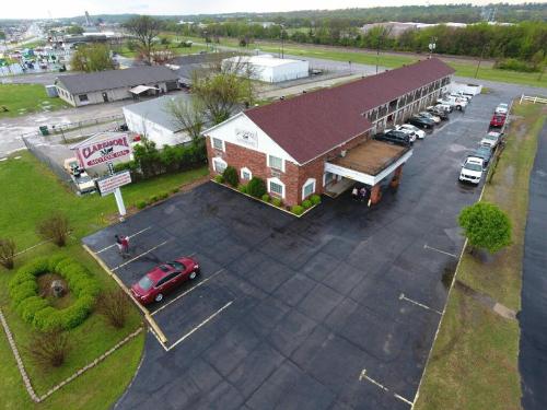 an overhead view of a large building with a parking lot at Claremore Motor Inn in Claremore