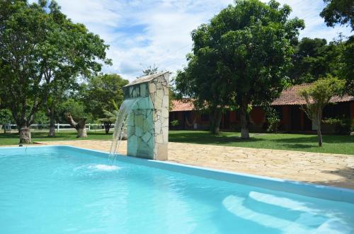 a water slide in a pool with a fountain at Pousada Rancho da Mata in Conservatória