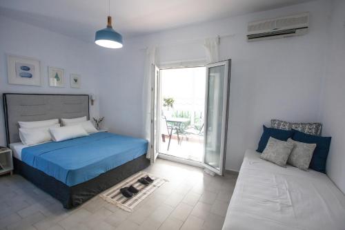 a bedroom with a bed and a couch at Kohili apartments in Pefkochori