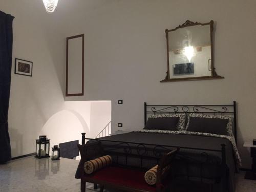a bedroom with a bed with a mirror on the wall at Ca' del Borgo in Venosa