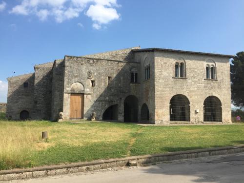 a large brick building with a brown door at Ca' del Borgo in Venosa