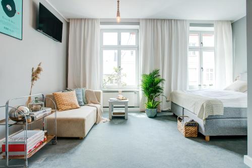 a living room with a bed and a couch at Apartamenty Chełmno in Chełmno