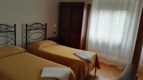 Postel nebo postele na pokoji v ubytování Hotel La Mimosa