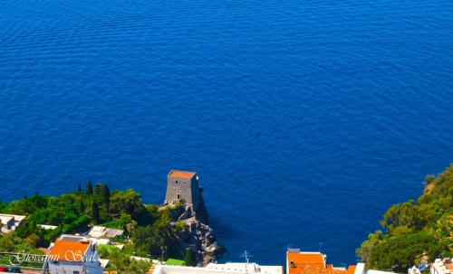 an aerial view of a building on a hill next to the water at Albadamare Boutique Hotel in Praiano