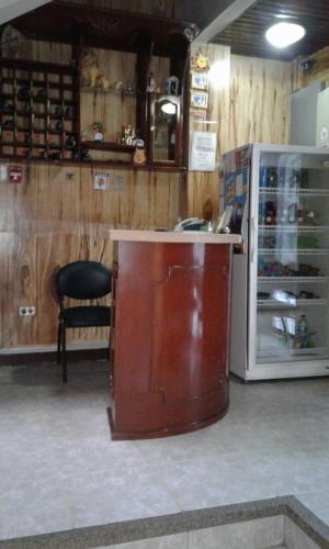 a room with a counter and a refrigerator in a store at Hotel Boston in Guayaquil