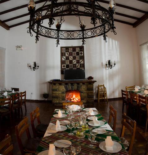 a dining room with a table and a fireplace at Centro Vacacional Huaychulo in Concepción