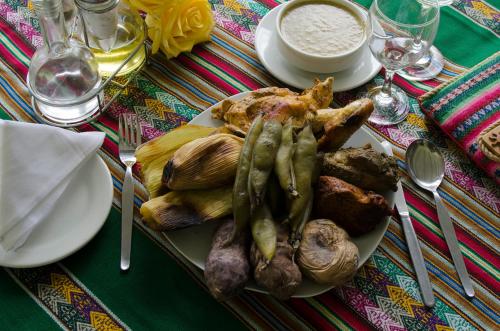 a plate of food with mushrooms and vegetables on a table at Centro Vacacional Huaychulo in Concepción