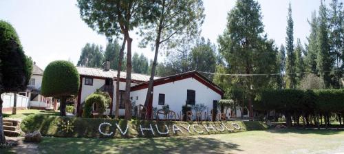a house with a sign in front of it at Centro Vacacional Huaychulo in Concepción