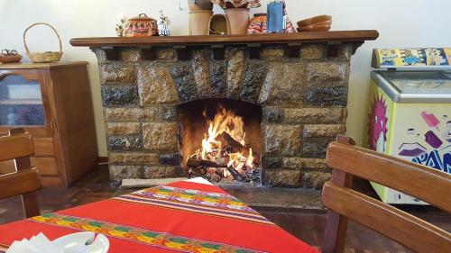 a fireplace in a living room with a table in front of it at Centro Vacacional Huaychulo in Concepción
