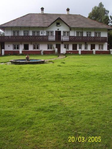 a large house with a large green field in front of it at Centro Vacacional Huaychulo in Concepción