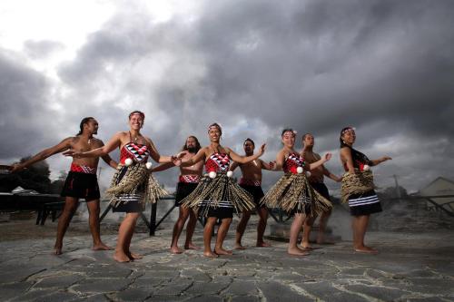 a group of women in skirts are posing for a picture at Greenview Motel in Rotorua