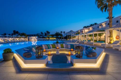 a pool at night with a resort at Gaia in Style - Adults Only in Tigaki
