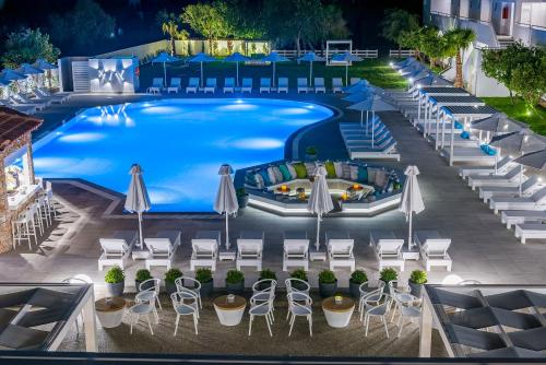 an overhead view of a pool with chairs and umbrellas at Gaia in Style - Adults Only in Tigaki