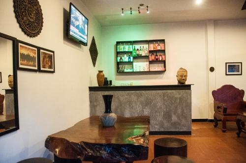 a room with a bar with a table and a counter at Private Boutique Home with Pool, The Fin Angkor Boutique in Siem Reap
