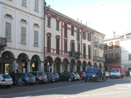a street with cars parked in front of buildings at Aer Hotel Malpensa in Oleggio