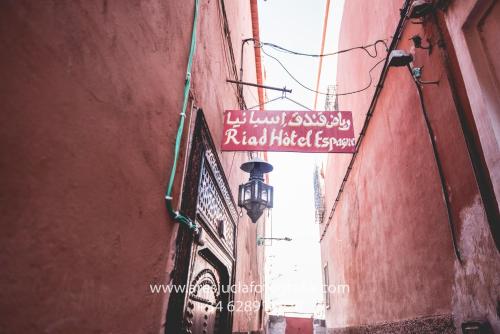 an alley with a sign on the side of a building at Riad Espagne in Marrakesh