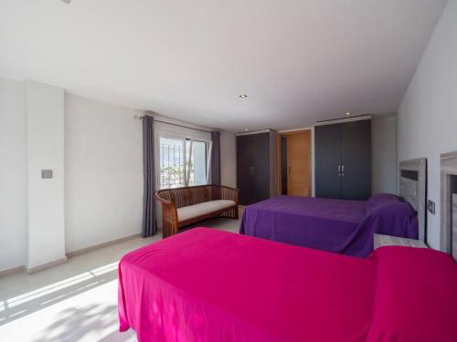 a bedroom with two beds and purple sheets at InmoSantos Casa Tordera in Roses