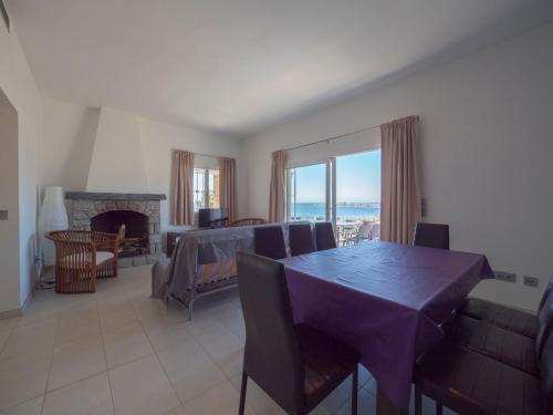 a dining room with a table and a fireplace at InmoSantos Casa Tordera in Roses