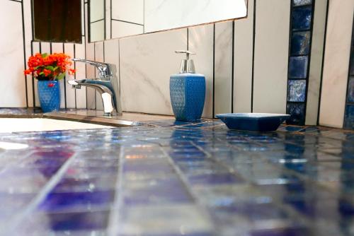 a bathroom counter with a sink and a bottle of soap at Omega Tours Eco-Jungle Lodge in La Ceiba