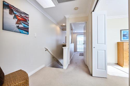 a hallway with white walls and a ceiling at Fremantle Townhouse Unit 4 in Fremantle