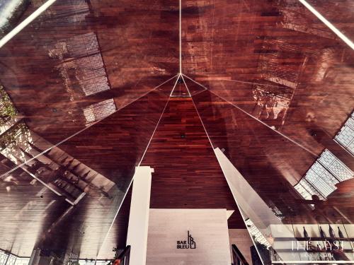 a ceiling of a building with a wooden at The Myst Dong Khoi in Ho Chi Minh City