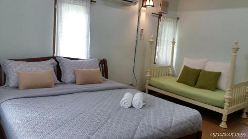 Ένα ή περισσότερα κρεβάτια σε δωμάτιο στο Rai Lung Tui Homestay