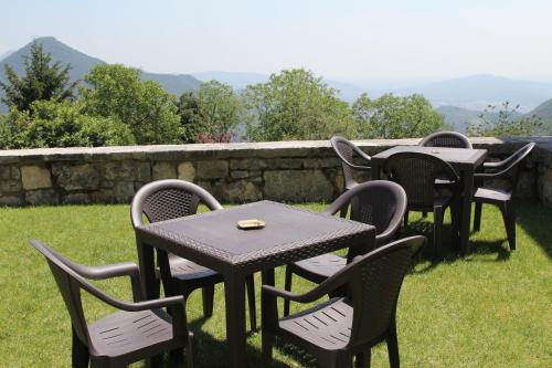 a group of tables and chairs sitting on the grass at Ca' Baetti l'Antica Corte in Roncola