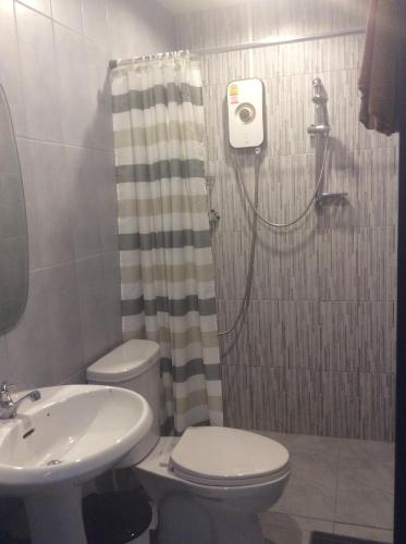 a bathroom with a shower and a toilet and a sink at Mountain View GuesthouseChiangmai in Chiang Mai