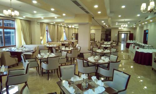 a restaurant with tables and chairs in a room at Sapphire Addis in Addis Ababa