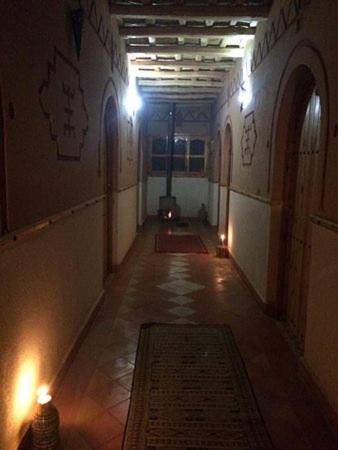 a hallway of a building with lights on the walls at Auberge des peupliers Café Restaurant in Akhendachou nʼAït Ouffi