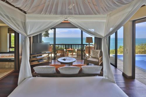 a bedroom with a bed and a view of the ocean at Pimalai Resort & Spa in Ko Lanta