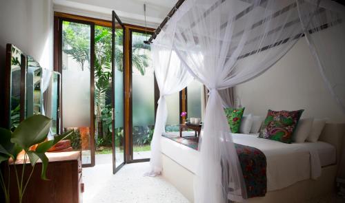 a bedroom with a bed with a canopy at Muntri Grove in George Town