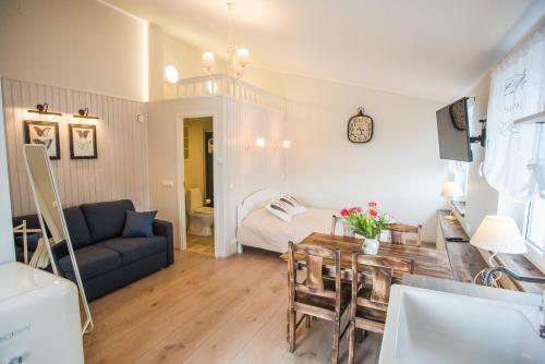 a living room with a couch and a table at Lapmanni apartments in Haapsalu