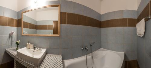 a bathroom with a sink and a bath tub at Apartmány LAGUNA in Kopřivnice