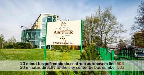 a hotel sign in front of a building at Hotel Artur in Kraków