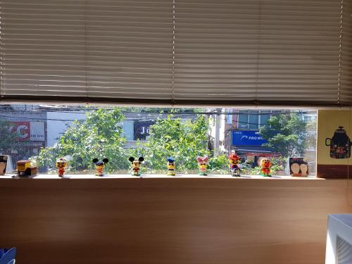 a window with a bunch of toy figurines on it at Sokcho & Guesthouse in Sokcho