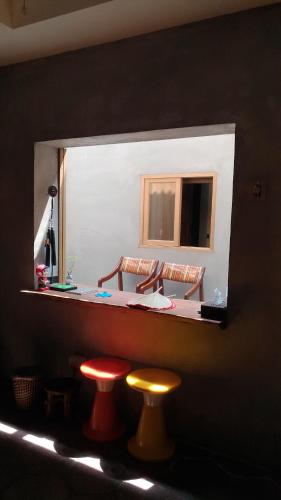 a counter with two stools in front of a mirror at YF 97.1 in Tainan