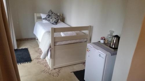Ένα ή περισσότερα κρεβάτια σε δωμάτιο στο Bauhenia Guesthouse